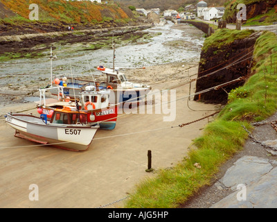 Quayside and Footpath Fishing boats moored in Boscastle Harbour at low water Boscastle Cornwall England UK Stock Photo