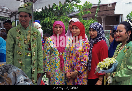 Wedding guests with bride and groom in green traditional dress Stock Photo