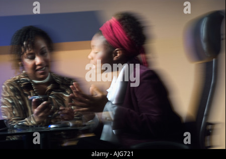 Two African American businesswomen in office meeting Stock Photo