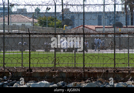 Federal Correctional Institution building on Terminal Island San Pedro Los Angeles California USA. Inmates in exercise yard. Stock Photo