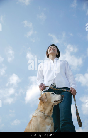 Young woman and Labrador retriever Stock Photo