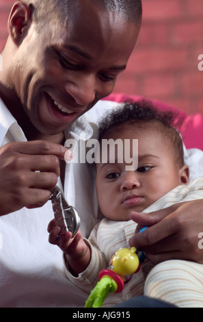 African American father playing with infant son Stock Photo