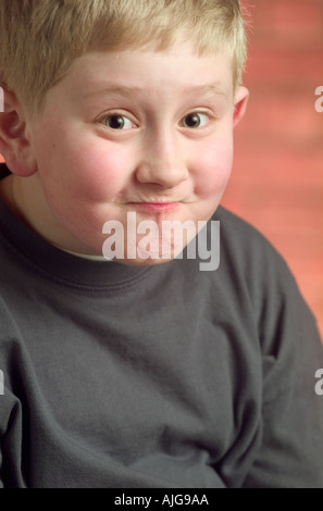 Portrait young Caucasian boy making a funny face Stock Photo