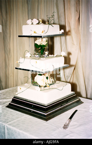 Three tiered wedding cake with a knife Stock Photo