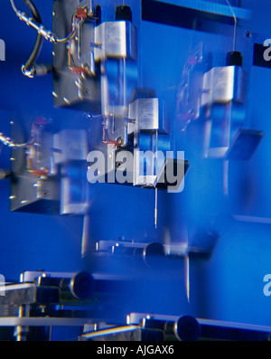 Multiple exposure of robot for filling capsules in large quantities used in pharmaceutical industry Stock Photo