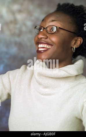 Portrait of a young single African-American woman wearing a white turtleneck sweater on the studio background Stock Photo