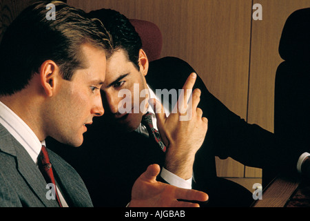 Two executives communicating and conspiring in a Business Meeting Stock Photo