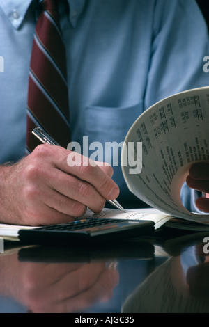 Caucasian businessman writing at desk Stock Photo