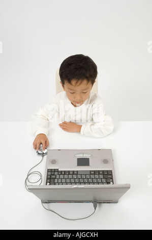 Elementary age boy using laptop Stock Photo