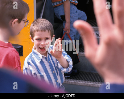 Kids riding school bus to school Stock Photo