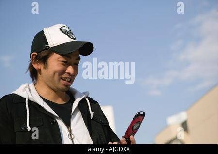 Young man using mobile phone Stock Photo