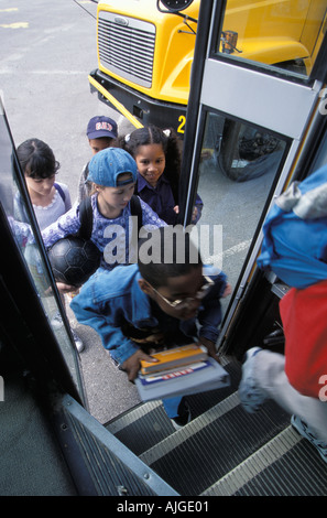 Kids riding school bus to school Stock Photo