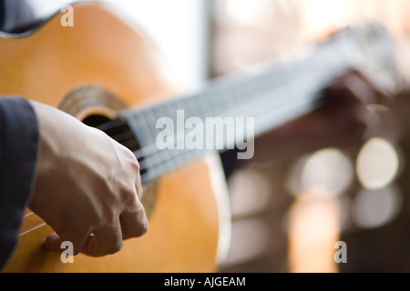 Young man playing acoustic guitar Stock Photo