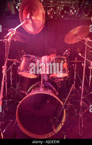 Young man playing drums on stage Stock Photo