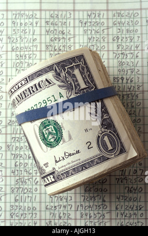 Cash roll of dollar bills on accounting records Stock Photo