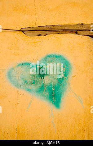 Green heart painted on an adobe wall in Tucson s barrio district Stock Photo
