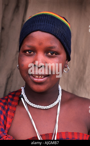 Masai woman in tribal dress and a rastafarian coloured cap north of Arusha en route to southern Kenya Tanzania Stock Photo