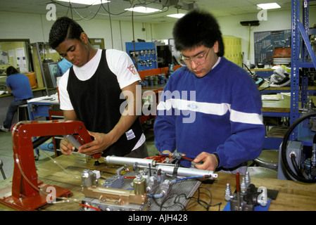 Vocational education Minority male high school students take training in Hydraulics Stock Photo