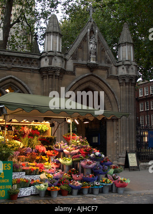 Flower sellers stall in front of Saint Mary Abbot Church Kensington High Street Kensington London England UK Stock Photo