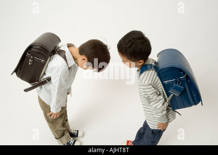 Two elementary age boys bowing Stock Photo
