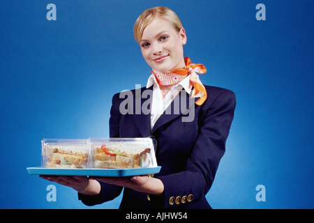 Air hostess holding a tray of sandwiches Stock Photo