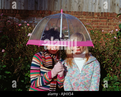 Two friends under an umbrella Stock Photo