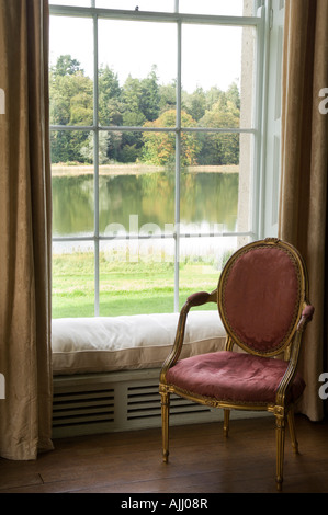 Louis XVI chair in front of a window with seat in 17th century Irish castle Stock Photo