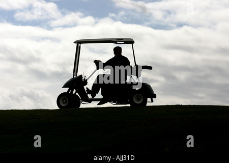 Silhouette of a golfer on his golf buggy on the Ailsa Course at Trump Turnberry Resort. Stock Photo