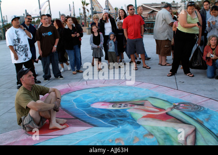 Julian Beever Pavement Artist Posing with a Woman in Swimsuit Created in Chalk on the sidewalk of Redondo Beach Stock Photo