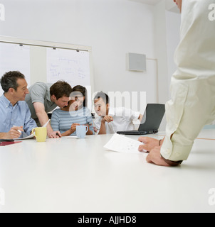 Office workers using a handheld computer Stock Photo