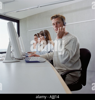 Three call centre operators Stock Photo