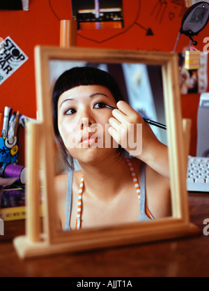 Teenage girl applying eyeliner Stock Photo
