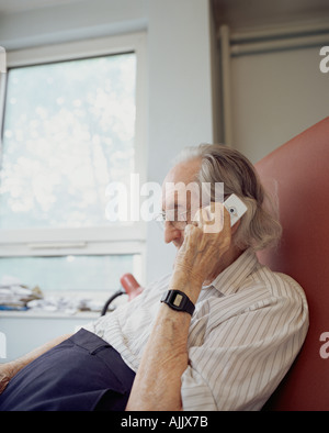 Elderly man using mobile phone Stock Photo