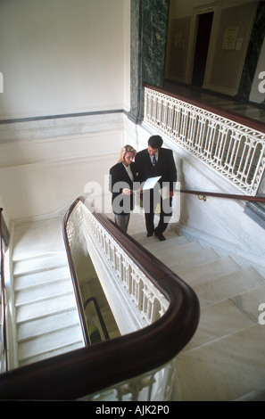 Business people on stairs Stock Photo