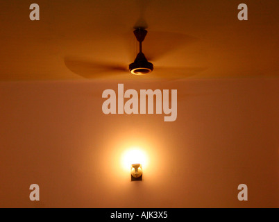 An image showing the subtleties of a room with the light and ceiling fan switched on Stock Photo