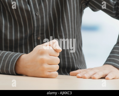Man banging his fist on table Stock Photo