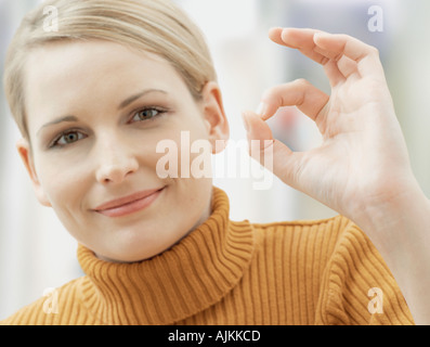 Woman giving OK sign Stock Photo