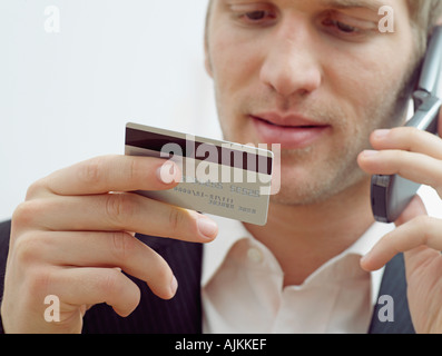 Man on mobile with credit card Stock Photo