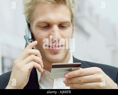 Man on mobile with credit card Stock Photo