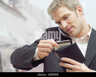 Man on mobile with credit card Stock Photo