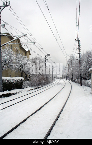 Railroad tracks receding in winter scene Stock Photo