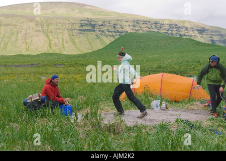 Friends setting up camp in the Aleutian Islands Alaska Stock Photo