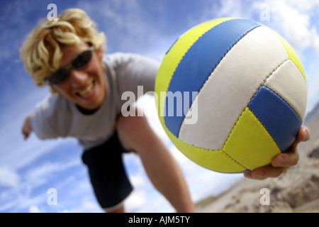 young blond man playing beach volleyball Stock Photo