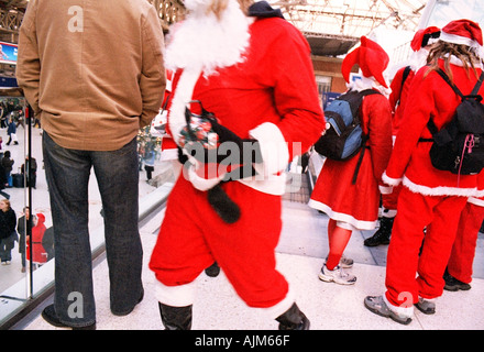 Gathering of Santas at Victoria Station in London December 2004 Stock Photo