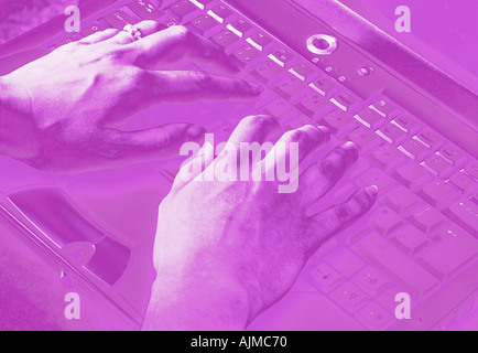 Laptop with Hands on Keyboard Digitally Manipulated Version in Shades of Magenta Stock Photo