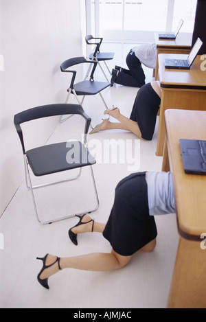 hiding under desk office worker