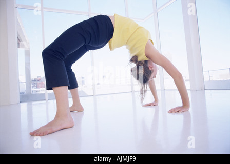 Woman bending over backwards Stock Photo