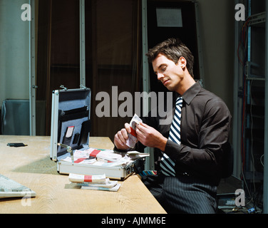 Man counting bundles of money Stock Photo