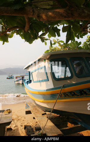 A fishing boat tied to mainland in Praia Japariz beach, Ilha Grande, Brazil Stock Photo