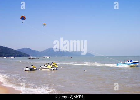 Parasailing and jet skis at Batu Ferringhi beach, Benang Island, Malaysia Stock Photo